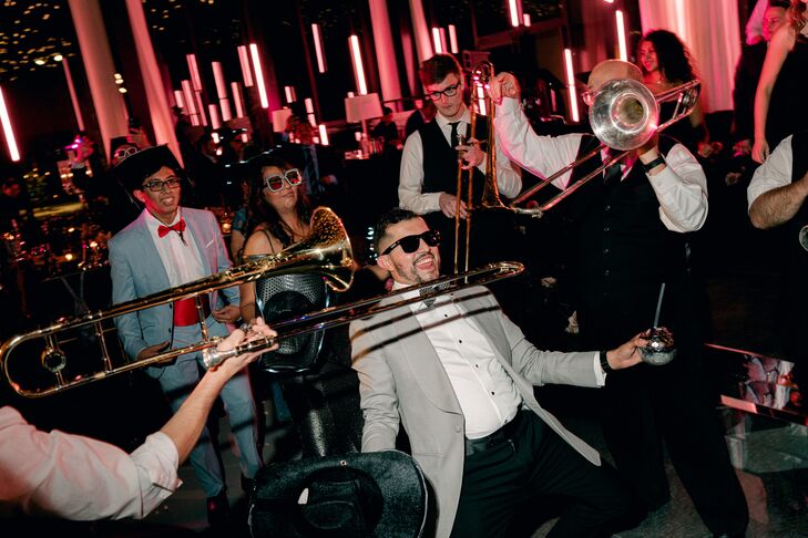 Groom Doing the Limbo While Trombone Players Make Reception Festive