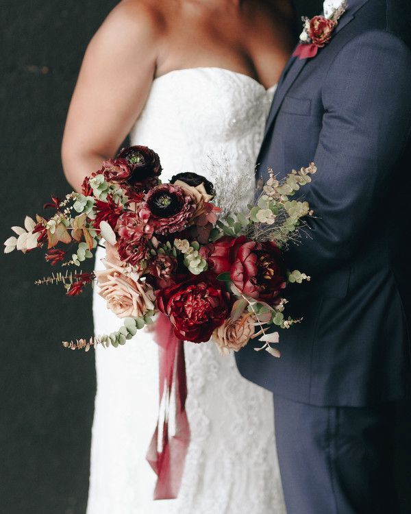 Bride holding burgundy bouquet