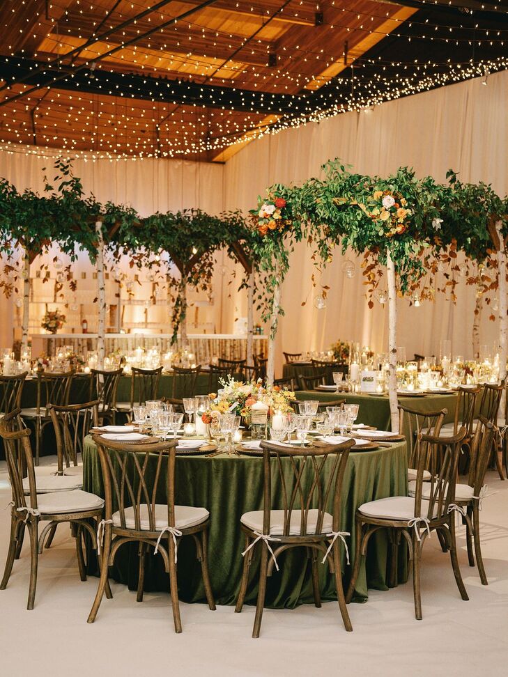 Rustic Wedding Reception With Wood Chairs and Green Linens