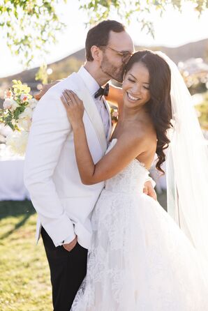 Bride With Loose Curls and Veil Hugging Groom