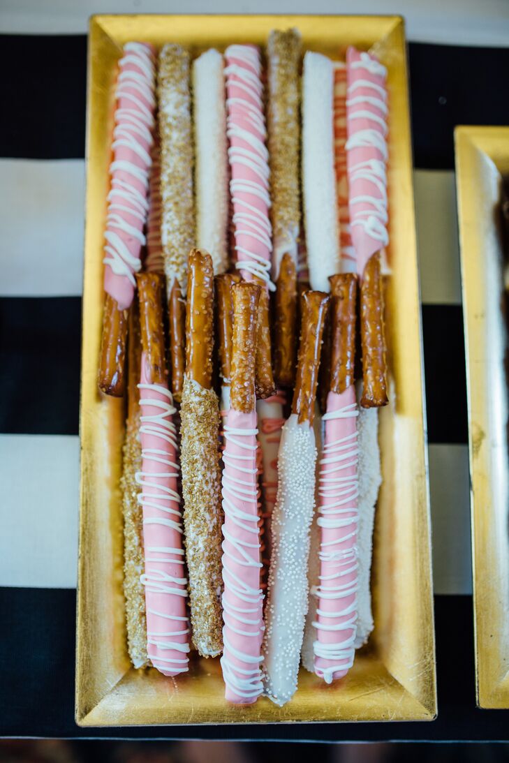 For wedding favors, Raquel and her mother made white-chocolate-dipped pretzels, along with heart-shaped sugar cookies, doughnut holes, Oreo and peanut butter pretzel truffles and assorted candies. All of the take-home desserts went along with the wedding day color palette.