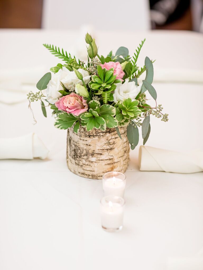 A lovely floral centerpiece with greenery and pink flowers.