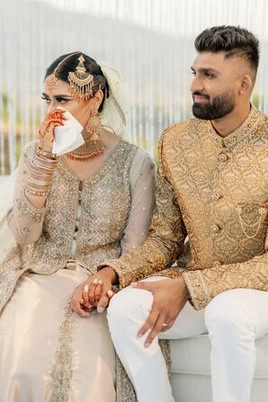 A Bride in a Traditional Pakistani Wedding Dress Tears Up Holding Hands With Groom