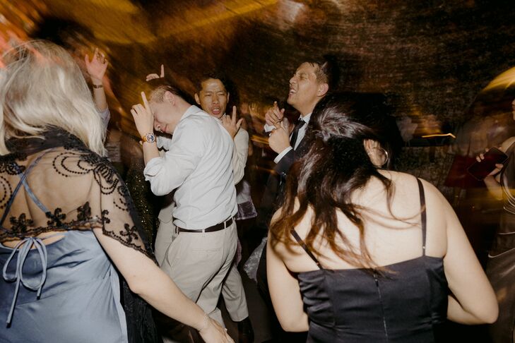 Artful Photo of Guests Dancing on Reception Dance Floor With Fun Light Effects