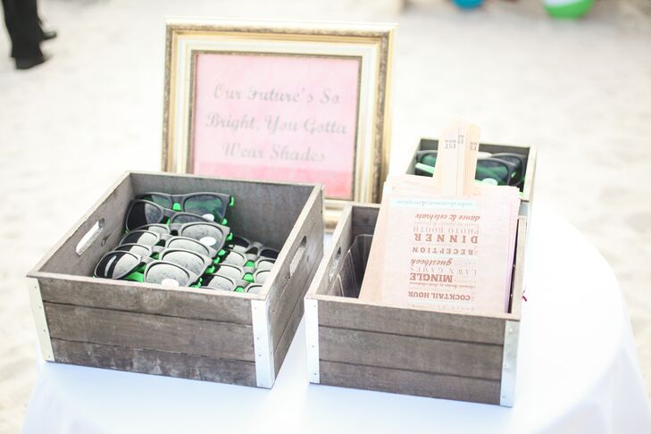 The couple gave their guests custom sunglasses and fan programs for the beach ceremony. The sunglasses were engraved with the words "don't be blinded by our love," says Chelsea.