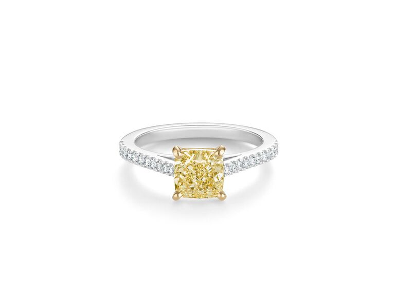 debeers cushion cut yellow diamond two tone engagement ring with yellow gold claw prongs and diamond encrusted white gold band