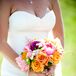 Michelle carried orange roses, pink peonies and plum carnations in her wildflower-inspired bouquet.