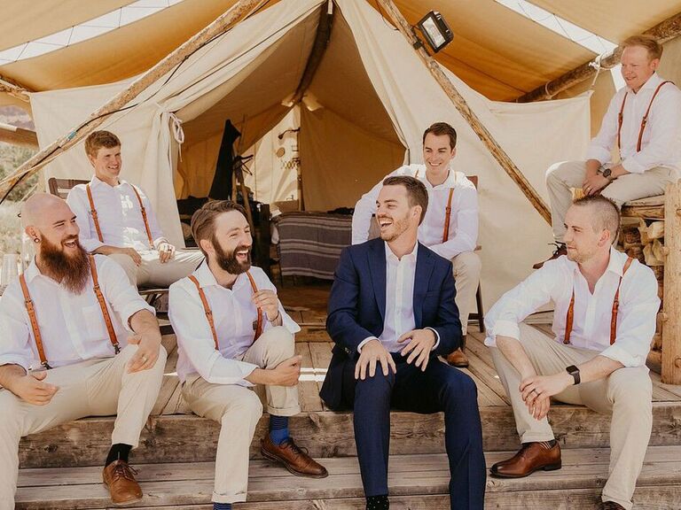 Groom chatting with groomsmen before wedding ceremony