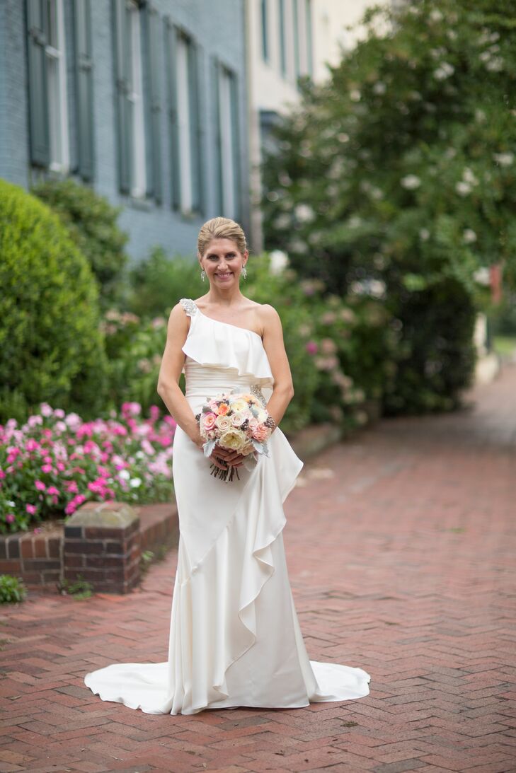Beth wore a one shoulder Maya Couture wedding dress draped with angled ruffles. The shoulder was decorated with rhinestones and the dress was fitted around the waist.