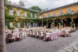 Italian Courtyard Reception Underneath String Lights With Blush Linens and Climbing Ivy