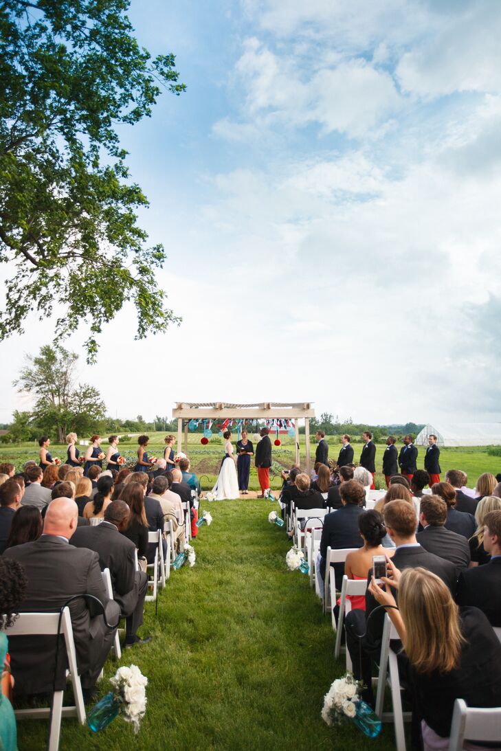 Simple decor—like blue mason jars filled with white flowers running the aisle—added just enough to the sprawling farm location.