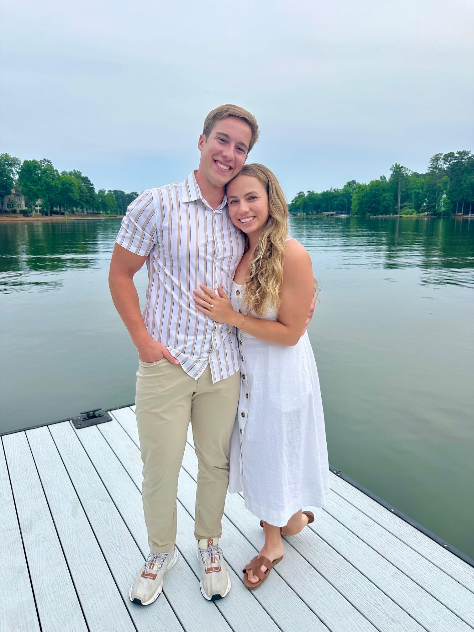 Ethan proposed to Sam on her parent's dock at Lake Oconee! She said yes (clearly). She even wore white and had no idea it was going to happen! Sam's whole family was in on it and helped get her outside for the surprise. 