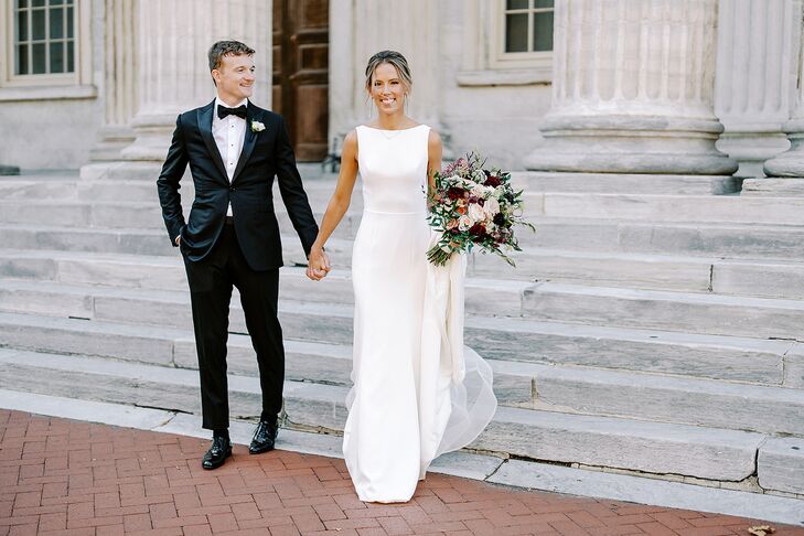 Groom in Sleek, Classic Tuxedo and Bride in Bateau-Neck Gown, Bouquet on Steps