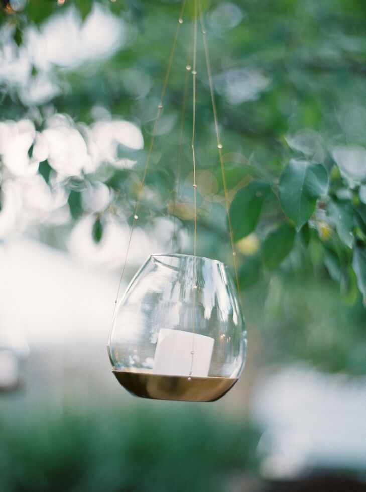 Hanging tealights in small vases adds an ethereal glow to an outdoor wedding and reception in Missoula, Montana.