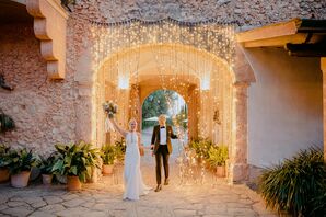 Couple Enters Mallorca Wedding Reception Through Curtain of String Lights