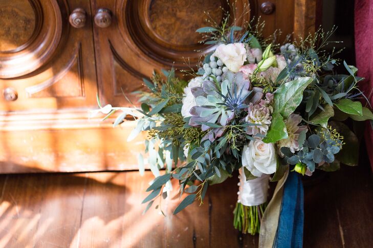 “Annie chose bouquets that were more wild, natural, and textured rather than tightly formed,” the couple says. “Bouquets made of cafe au lait dahlias, spray roses, succulents, blue eryngium, white freesias, seeded lemon leaves, mums and seeded eucalyptus sprayed gold were wrapped with gold and dark teal ribbons to match the palette.”