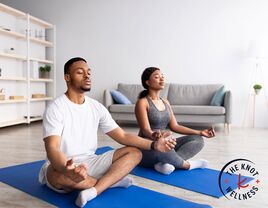 Couple meditating together at home