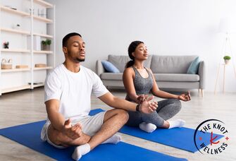 Couple meditating together at home