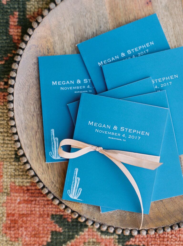 Blue wedding programs with cactus illustrations