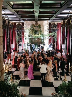 Guests in Formal Attire on Checkered Dance Floor, Greenery and Candles at Castle-Like Estate