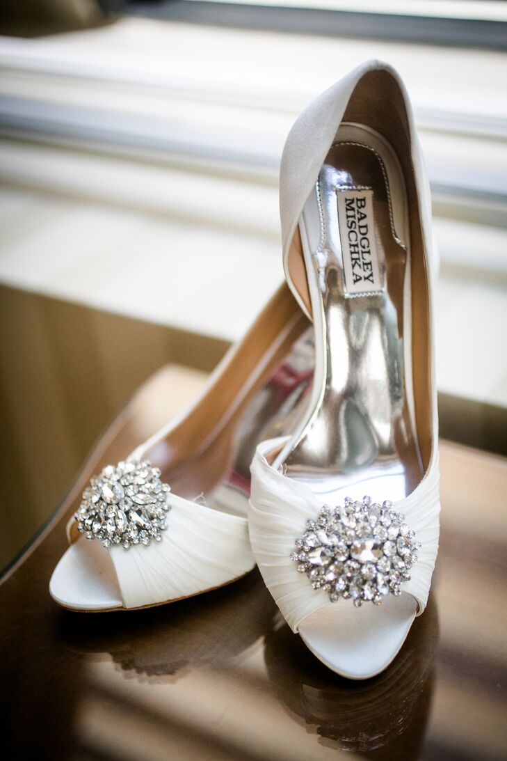 To fit the wedding's opulence and formality, Rebecca accessorized her custom Augusta Jones gown with a few glitzy details. A crystal-embellished belt accentuated her waist while adding an undeniable glam touch to her bridal look, while D’Orsay-style Badgley Mischka heels were undeniably elegant and refined.