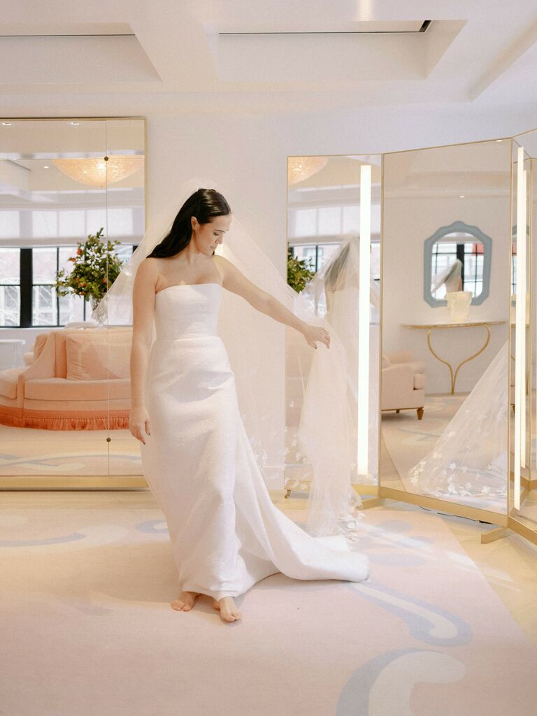Bride tries on a wedding dress at a boutique. 