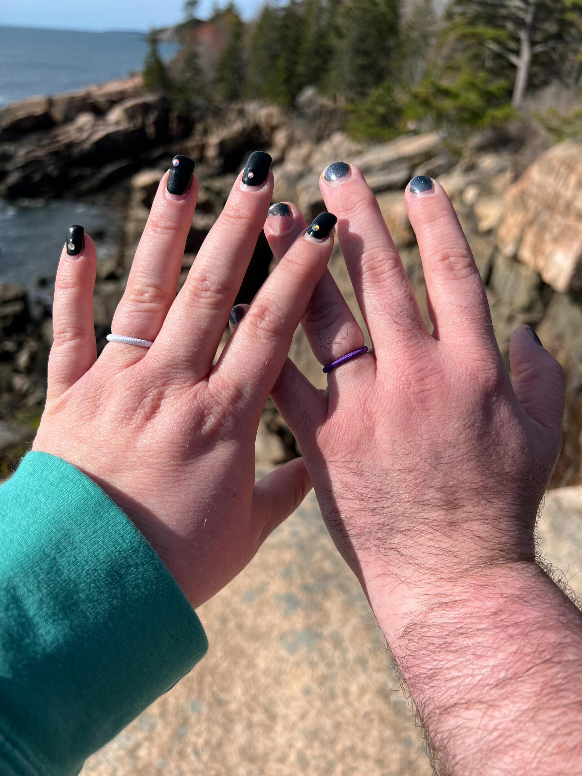 In May 2022, Sebastien proposed on a sun-washed rock outcropping overlooking the Atlantic in Acadia National Park. He didn’t have a traditional ring—just a couple of tiny hair ties from work—because he knew Hillary wanted to design her own. Hillary also proposed on this day, with the second hair tie. And it was perfect.