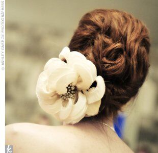 To prepare for an evening of dancing, Dixie’s stylist pulled her hair into a loose updo after the ceremony. The brooch in the center of the flower comb was Dixie’s great-grandmother’s.