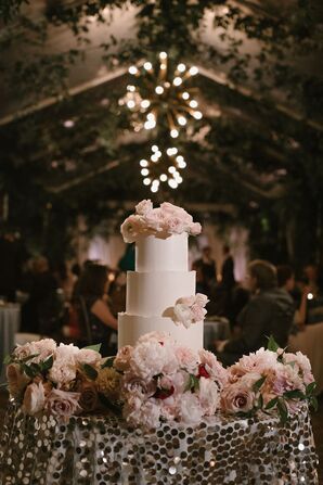 Three-Tier White Wedding Cake With Live Pink Flowers and Sequined Linen