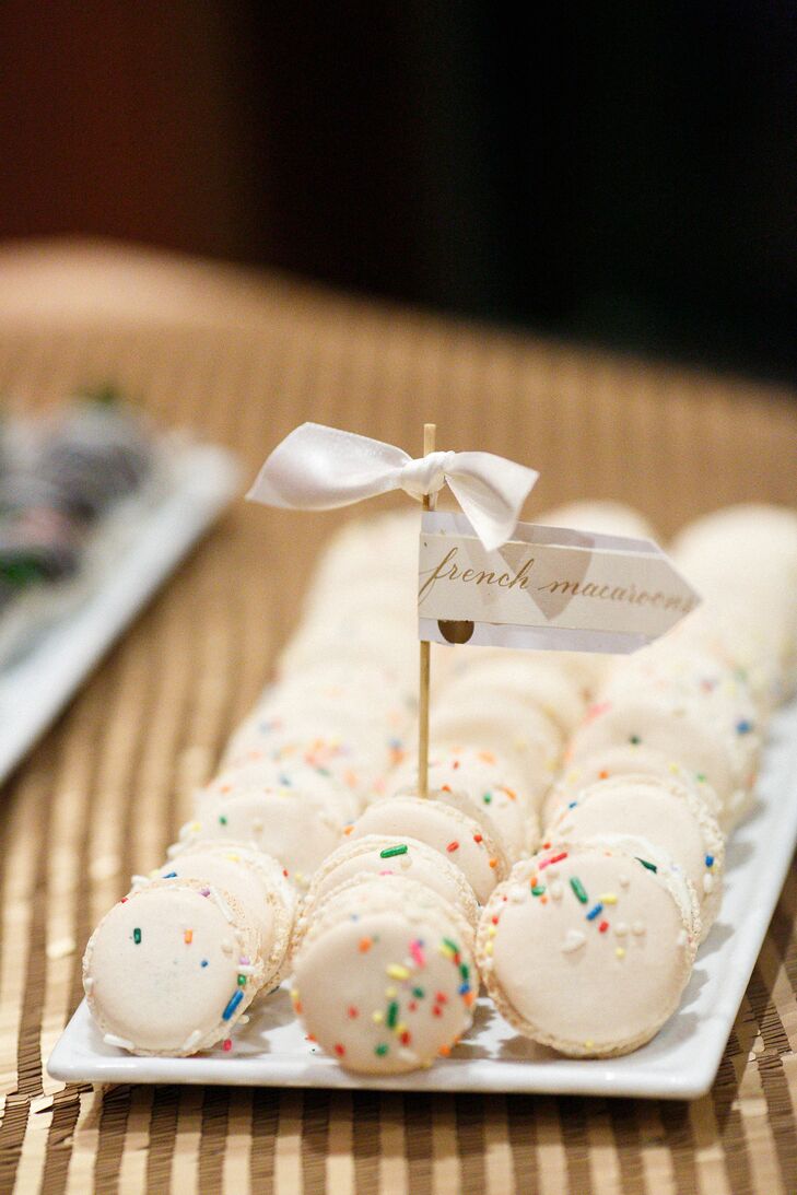 On top of a four-tier cake, Tiffany and Joe treated their guests to a table of sweets. French macarons covered in sprinkles were just the tipping point. Olives, a local restaurant, also served chocolate-covered strawberries and mini cannoli. (Yum!)  A matching white ribbon tag highlighted each plate.