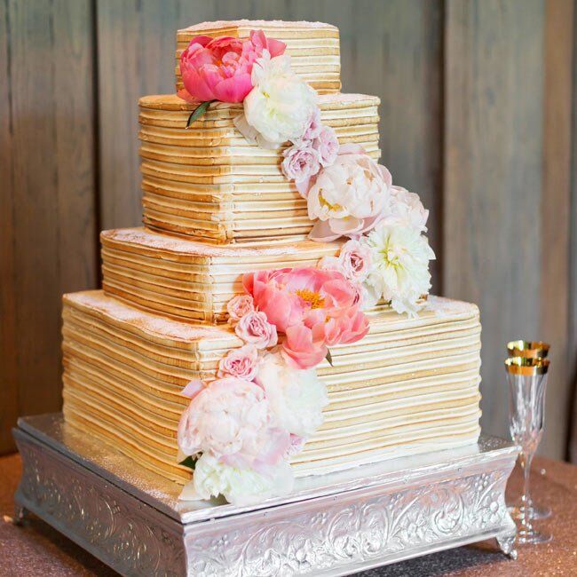 The six-tier, quatros-leches cake had a meringue filling and was decorated with a cascade of lush peonies and garden roses.