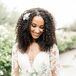 Bride With Curly Hair and Long-Sleeve Wedding Dress