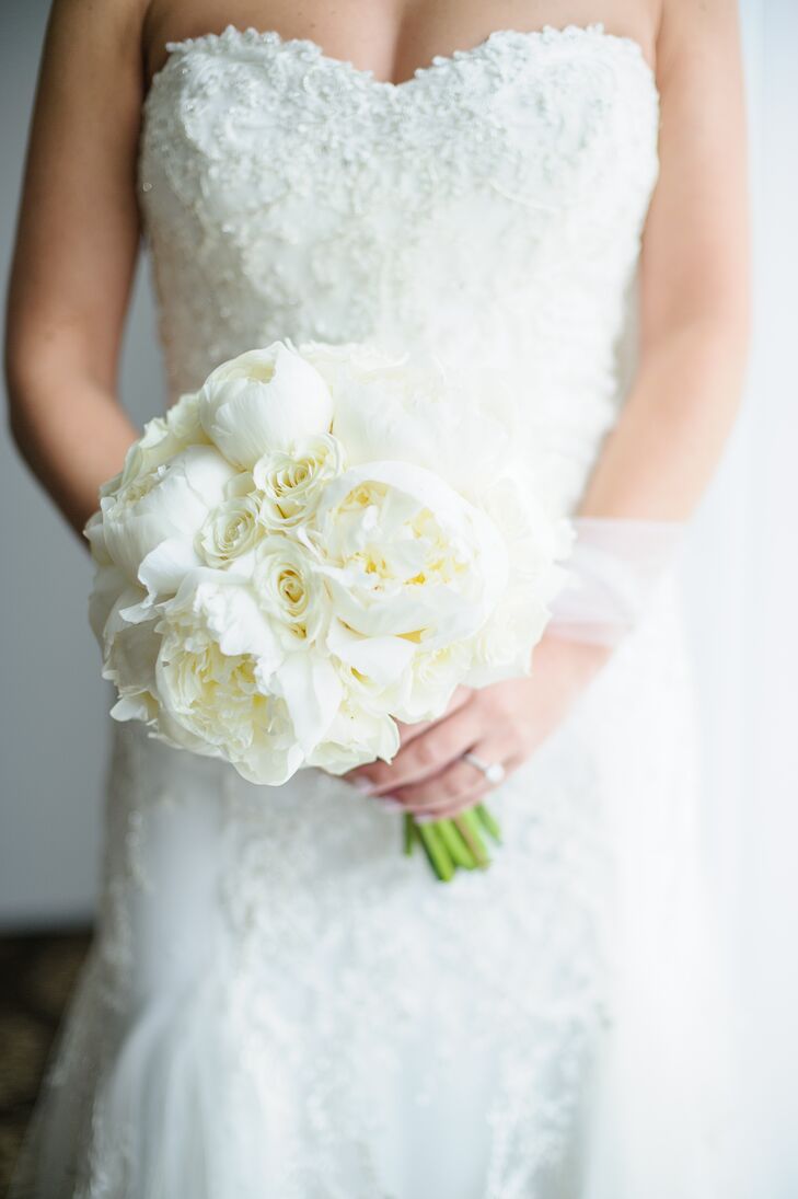 “I am actually not very picky on flowers,” says Lauren, “so I gave the florist pretty much full reign on picking them. I knew I wanted white and that was about it.” Edge Flowers created a lush, romantic bouquet for Lauren to carry down the aisle, the perfectly arranged bundle filled with full peonies and roses in soft shades of ivory and white.