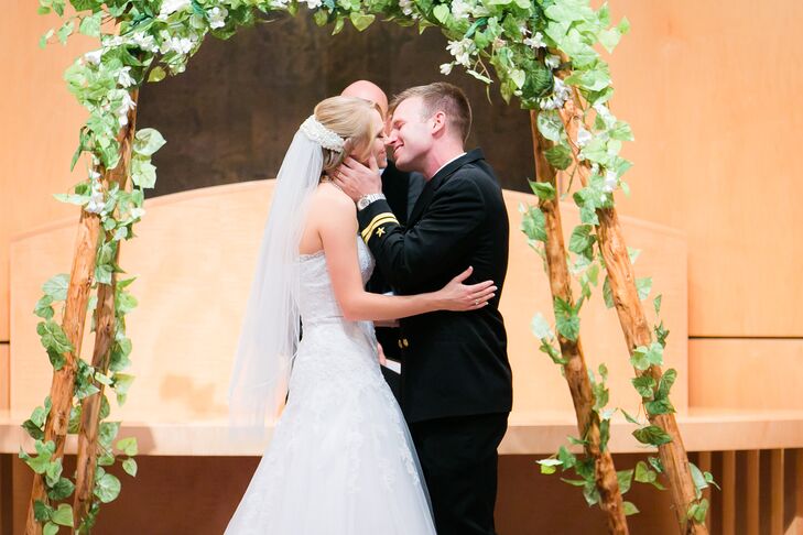 First Kiss at Wedding Arch