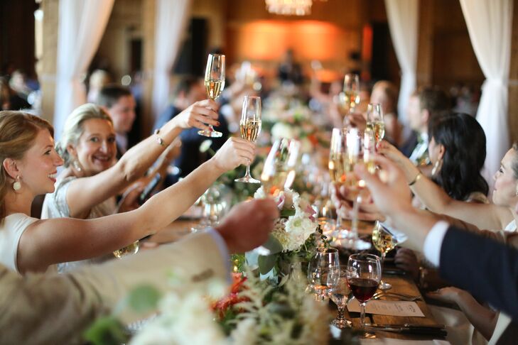 Guests raised their champagne glasses to toast the newlyweds at the reception.