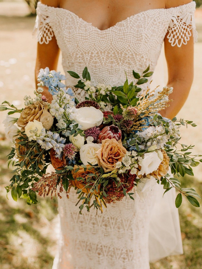 Bride holding boho brown wedding bouquet