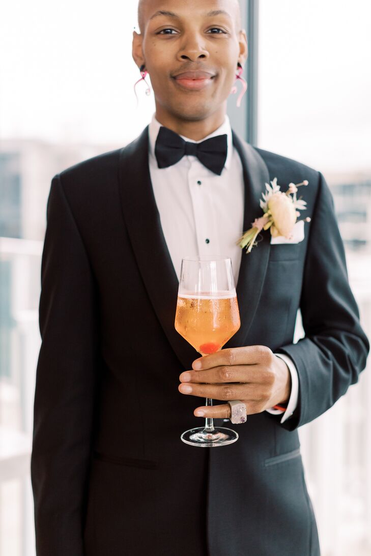 Person in Tuxedo Holding Orange Cocktail