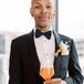 Person in Tuxedo Holding Orange Cocktail