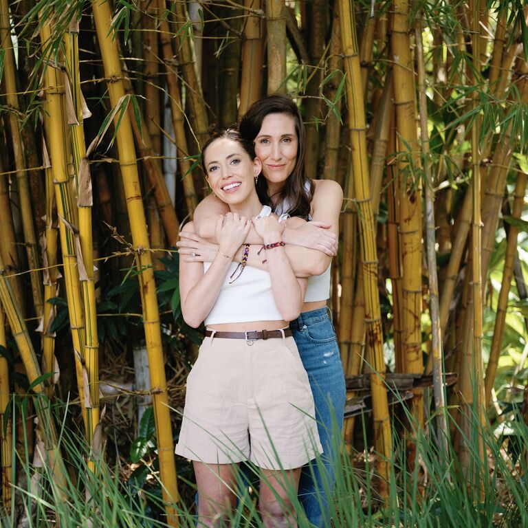 Hugging engagement photoshoot among bamboo