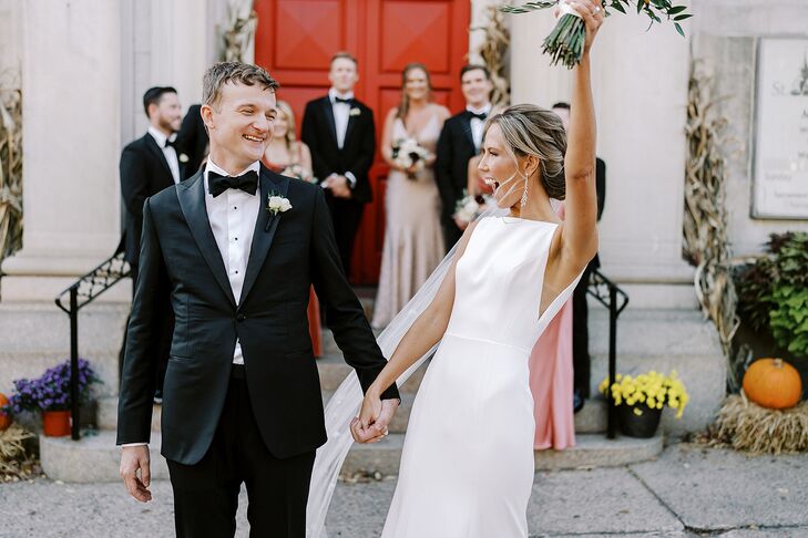 Groom in Tuxedo and Bride With Long Veil Recessional Outside Catholic Church