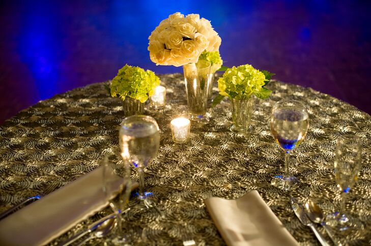 In keeping with her traditional aesthetic, Leslie decorated her blue, ivory and green ballroom reception with hydrangea and rose arrangements.rn