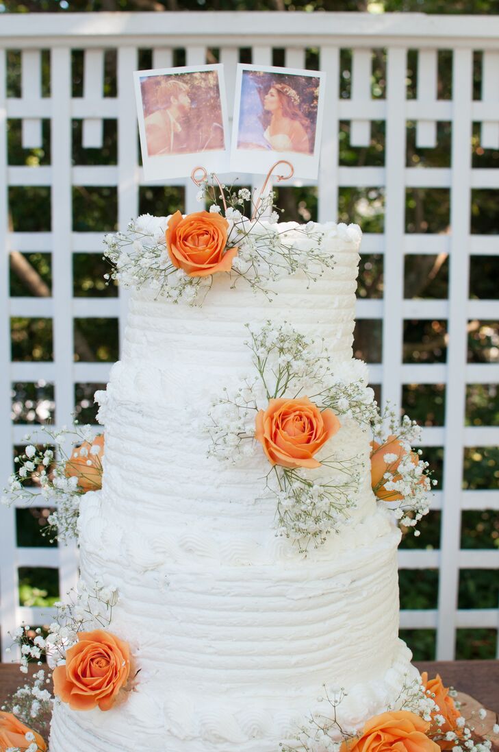 Even their wedding cake had a personal touch. To make the topper, Conner grabbed his Polaroid camera and snapped a few pictures of them that day! Below the accent, their confection was filled with chocolate, lemon, strawberry and red velvet cake covered by a layer of buttercream frosting. Orange roses and baby's breath decorated each tier to tie in their DIY arrangements.