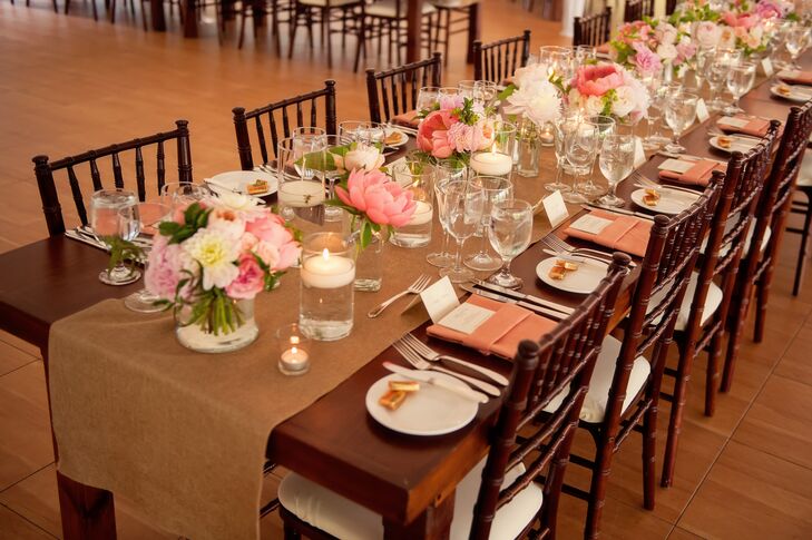 Long, wooden farmhouse tables were topped with burlap runners and lop arrangements of pink peonies and garden roses.