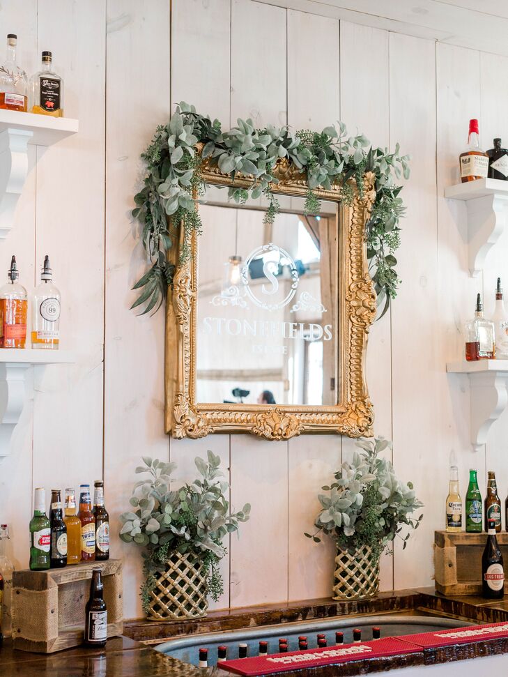 Rustic Bar with Decorative Mirror and Greenery