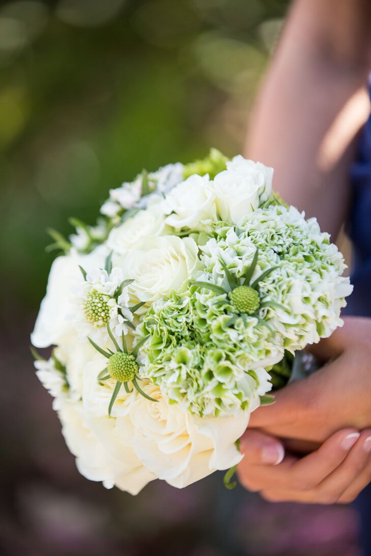 For the bridal party bouquets, they used white  roses, green scabiosa and white and green hydrangeas to contrast the deep blue bridesmaid dresses.