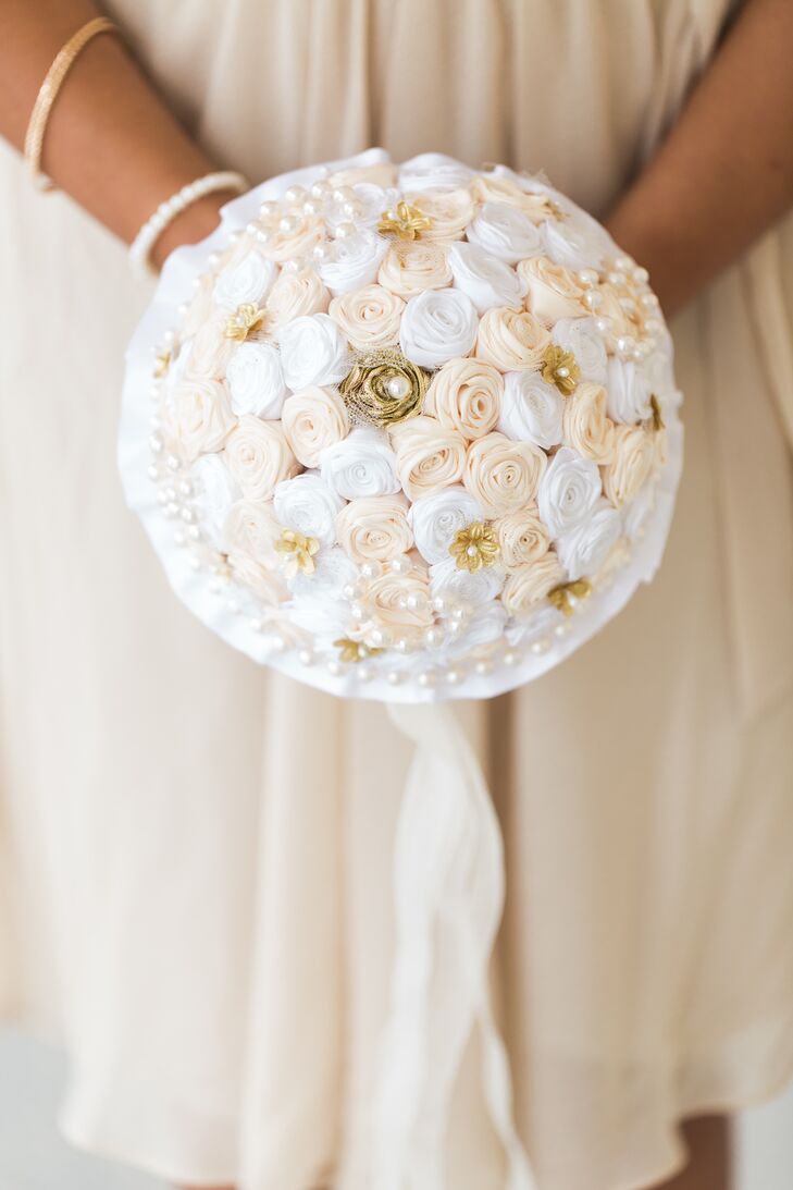 Showing off the day’s vintage style, each bridesmaid paired her dress with handmade fabric bouquet. Rose-inspired blooms in champagne and pure white ribbon covered the arrangements alongside gold accents with pearl centers. Strands of additional pearls wrapped around their bouquets. “I wanted each piece to have a significant meaning,” Jaris says. “Having my family and friends make these pieces meant the world to me.”