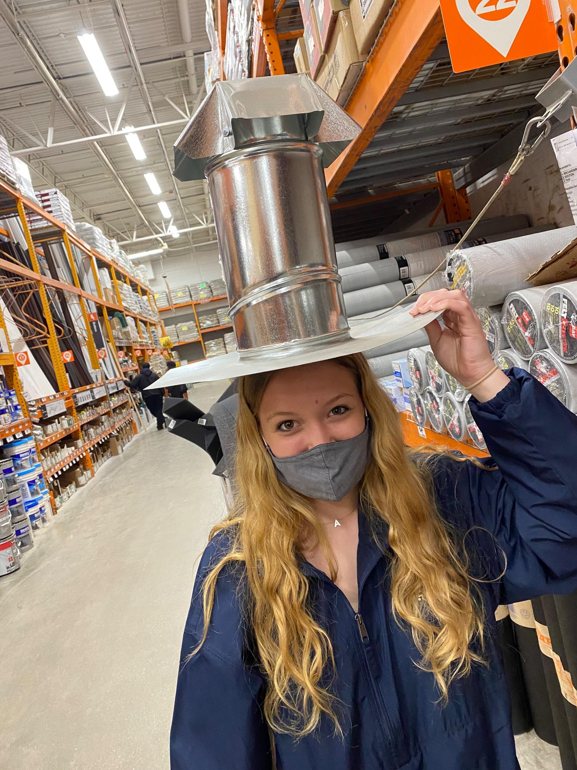 Annie trying on hats at Home Depot 