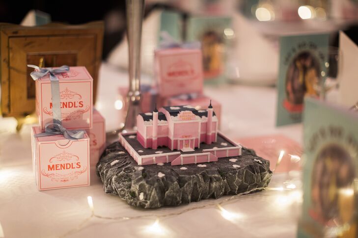 Another centerpiece at the reception was a miniature of the hotel from 'The Grand Budapest Hotel.' As wedding favors, Louise and Oscar gave their guests Mendl's Patisserie cake boxes with magnets in them.