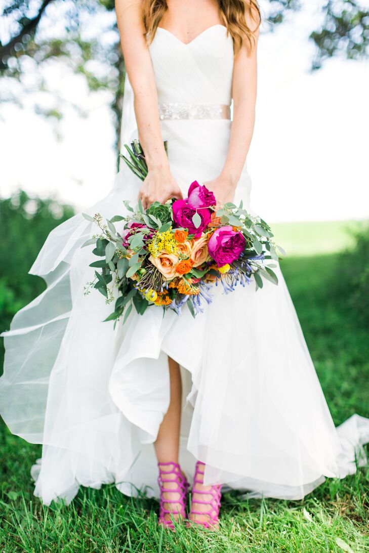 "I have a very modern style,” Molly says of her punchy wedding day look. She accessorized her strapless, white sheath-style dress with a pair of hot pink Schutz heels for an added pop of color.