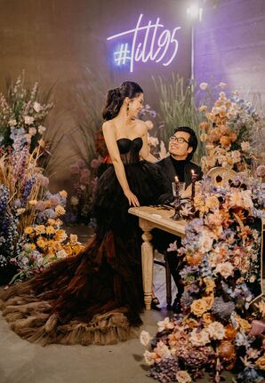Bride in Strapless Black Wedding Dress Sitting With Groom